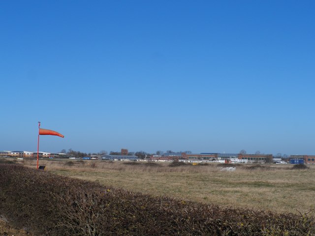 Cranfield Airport with windsock and newly cut hedge