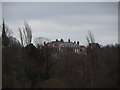 View of a large building on Highgate West Hill from the hill at the back of Kenwood House