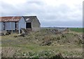 Old runway, sheds and debris 