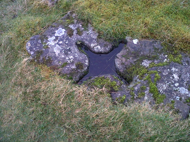 A stone below the monument on Dùn Athaich