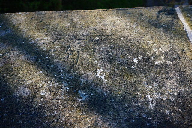 Carving on a stone bridge parapet; Indianhead