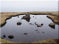 HU6771 : Pond with a cairn by Julian Paren