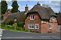 Thatched cottages on street corner in West Meon