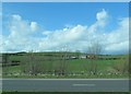 Farm buildings and a modern farmhouse west of the A1