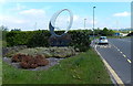 Oakdale Business Park name sign and distant wind turbines