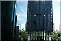 View of a reflection of buildings on Ropemaker Street in Ropemaker Place