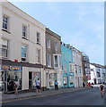 SN1300 : Cyclist passes Tenby Cycles shop by Jaggery