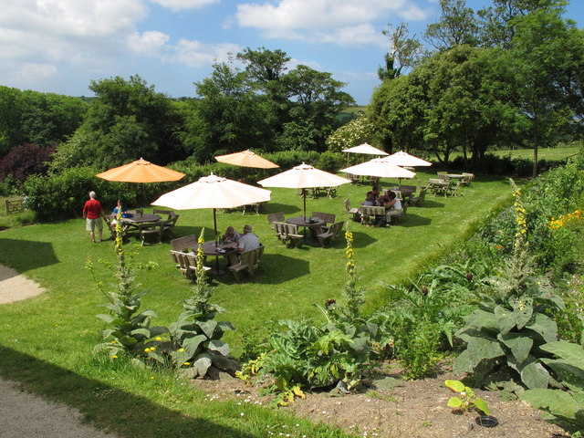 Lawn at Trerice with cafe tables and umbrellas