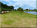 Hay bales next to a flooded quarry