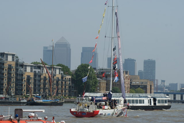 View of the British vessel doing its sail of honour against the backdrop of Canary Wharf
