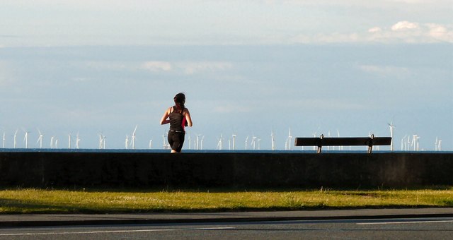 Jogger, bench and wind farm