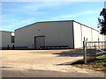TM0190 : Hangar on the Oakwood Industrial Estate by Evelyn Simak
