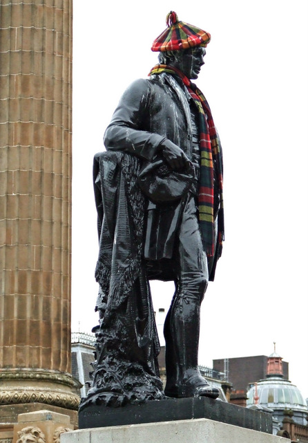 Rabbie Burns with tartan scarf and bonnet