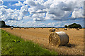 SD3706 : A field of baled hay by Ian Greig