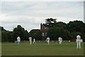 View of the cricket match against the backdrop of a large house