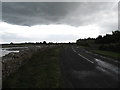 J5946 : Under a cloud - the Shore Road north of Kilclief by Eric Jones