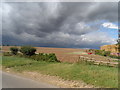 Harvested field and threatening sky