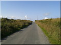 Lane with wind turbines on the horizon