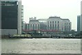 View of a DLR train, Tower Hamlets Town Hall, Balfron Tower and Blackwall Yard from the Greenwich Peninsula