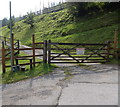 Public footpath stile and a warning on a gate, Tylagwyn