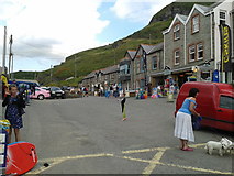 SX0486 : Shops, houses, cars, people, dogs at Trebarwith Strand by Rob Purvis
