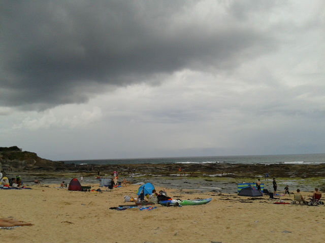 On the beach, under a cloud, at Constantine Bay