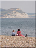 SY3491 : Lyme Regis: a couple enjoying the beach and the view by Chris Downer