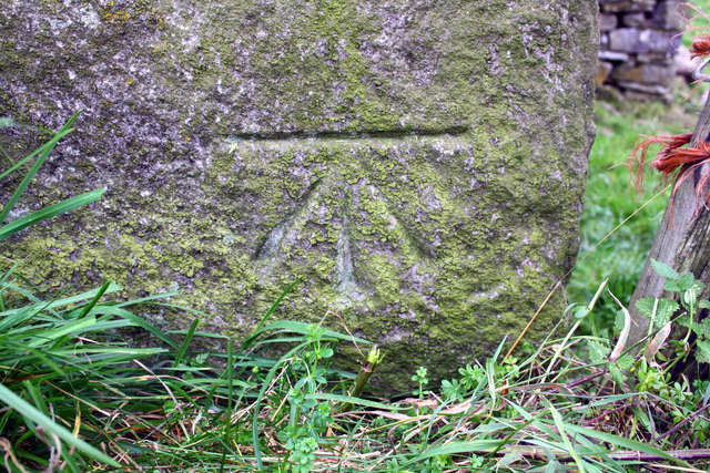 Benchmark on barn beside B6259 at Outhgill