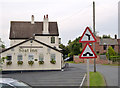 Left hand bend ahead, with road junction right