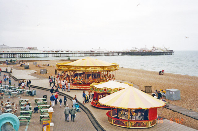 Brighton, 2002: round-abouts on shore by Palace Pier