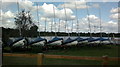 TQ5784 : View of a row of boats moored up next to Russell's Lake by Robert Lamb