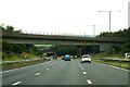 The M65 runs east under a railway bridge