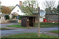 Road signpost and bus shelter