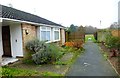 Looking out of path between dwellings to recreation ground