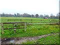 Footpath crosses track using two stiles