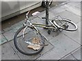TQ3481 : Oops! A damaged bicycle on Whitechapel High Street by Roger Cornfoot