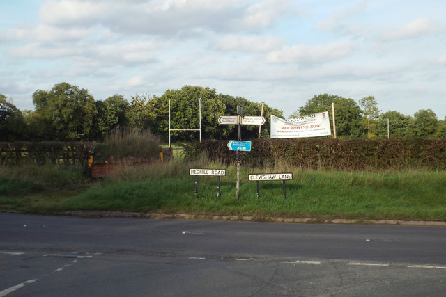Road signs at Forhill with Woodrush Rugby Club ground beyond