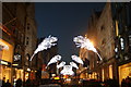 TQ2881 : View of peacock feather Christmas decorations on New Bond Street #2 by Robert Lamb