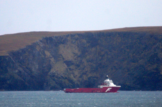 The supply vessel Far Reacher sheltering beside the 'Blue Banks' of Fetlar