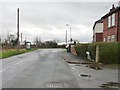 Bus stop at a 24 metre spot height, near Little Smeaton