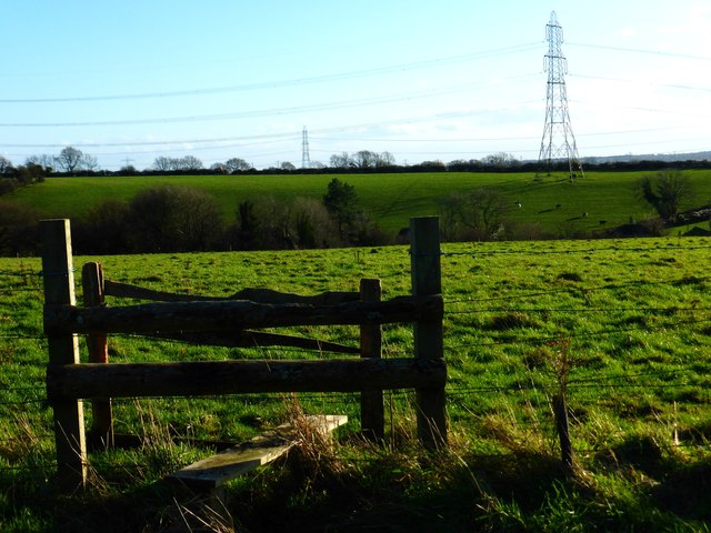 Rickety double stile with barbed wire