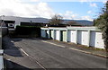 Eight lockup garages in the SW corner of  Ffynnonau, Crickhowell