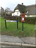 TL2356 : High Street Postbox & Harbins Lane sign by Geographer