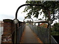 Tubular footbridge alongside a road bridge in Oswestry