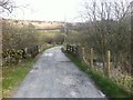 Road and bridge over Marglolly Burn at the west end of Glenkiln reservoir