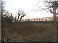 TQ2472 : Train passing Wimbledon Park by David Howard