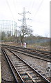 Electricity pylon and gas holders at railway junction