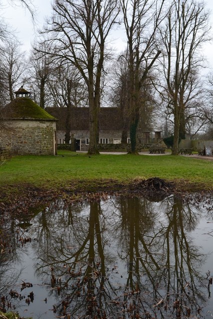 Reflections in farmyard pond at Avebury Manor