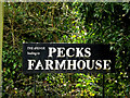 TM1576 : Pecks Farmhouse sign by Geographer