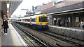 Northbound Overground train entering Surrey Quays station